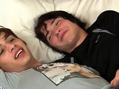 Three perfect twinks kiss inwards in bed